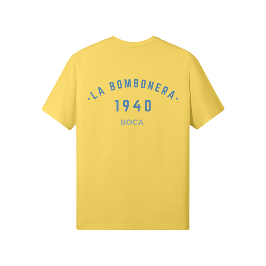 Front and back of a Boca gold t-shirt featuring La Bombonera 1940 and Boca Juniors sky blue text. Inspired by the iconic Argentinian stadium and terrace culture.

